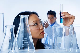 Scientist Looking at Vial